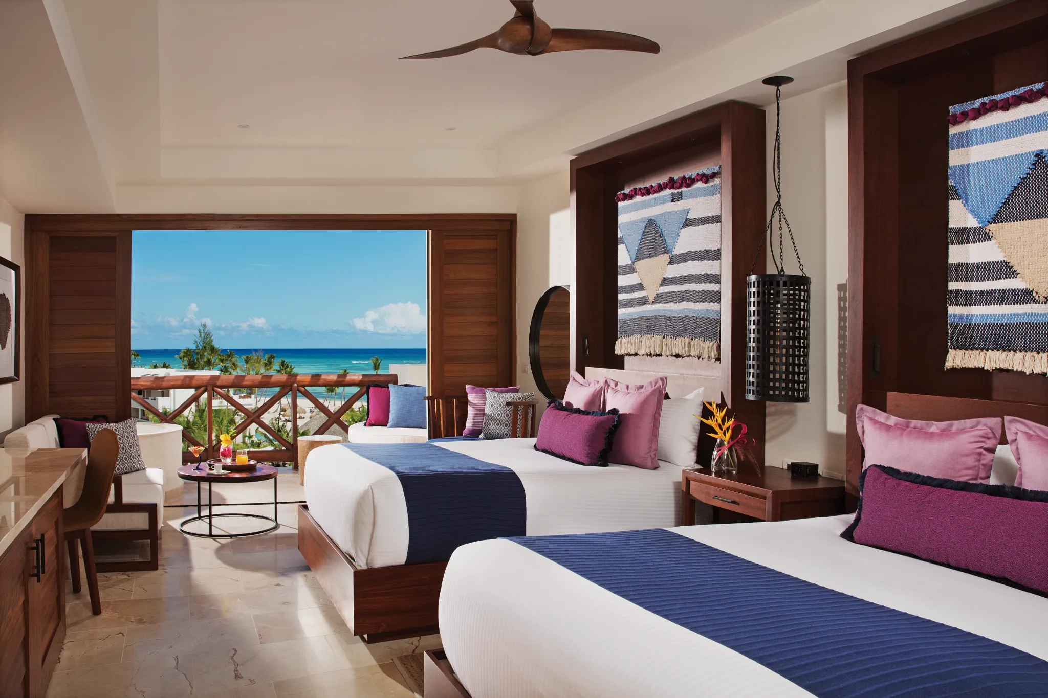 Junior Suite with two double beds and resort views at Secrets Cap Cana Resort & Spa.