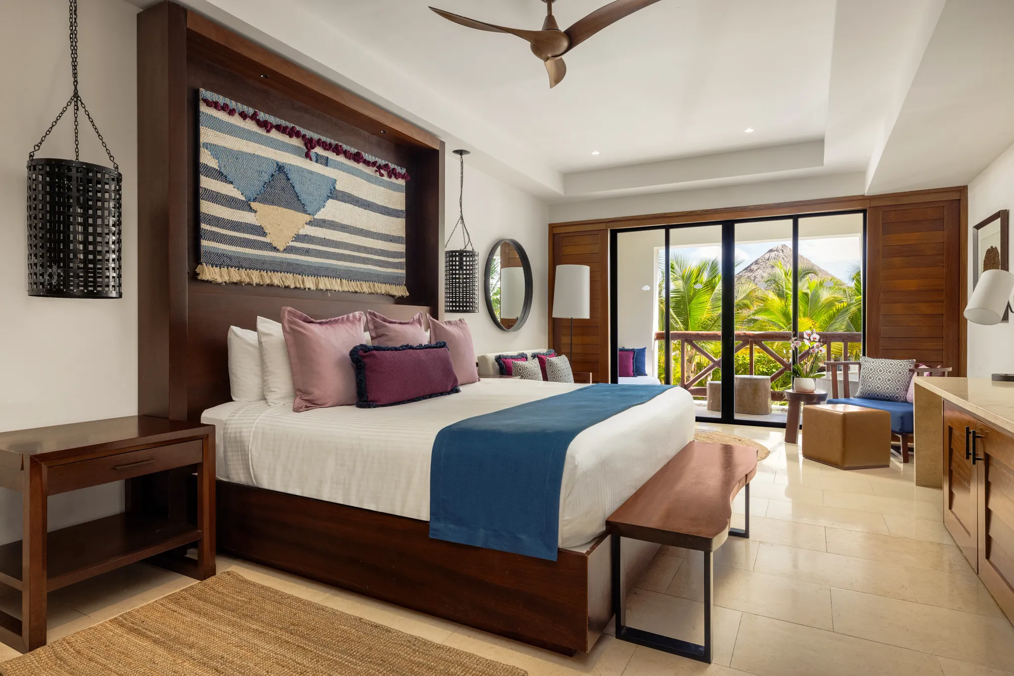 Junior Suite Tropical View with king bed and furnished balcony at Secrets Cap Cana Resort & Spa.