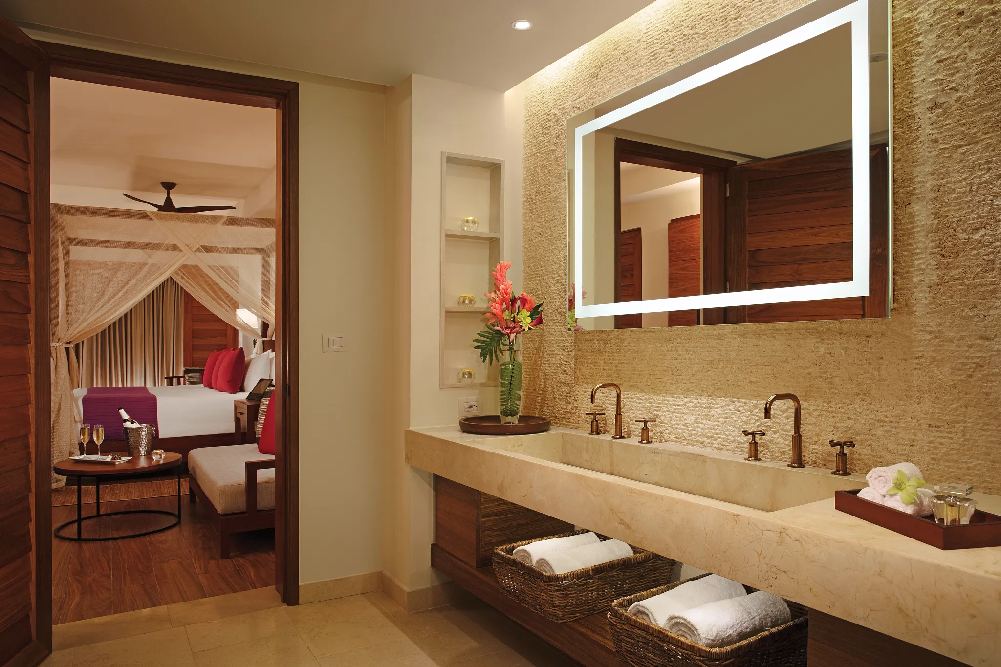 Preferred Club Bungalow Master Suite Pool View bathroom with double vanity, illuminated mirror, natural stone finishes, and luxury spa-inspired design.