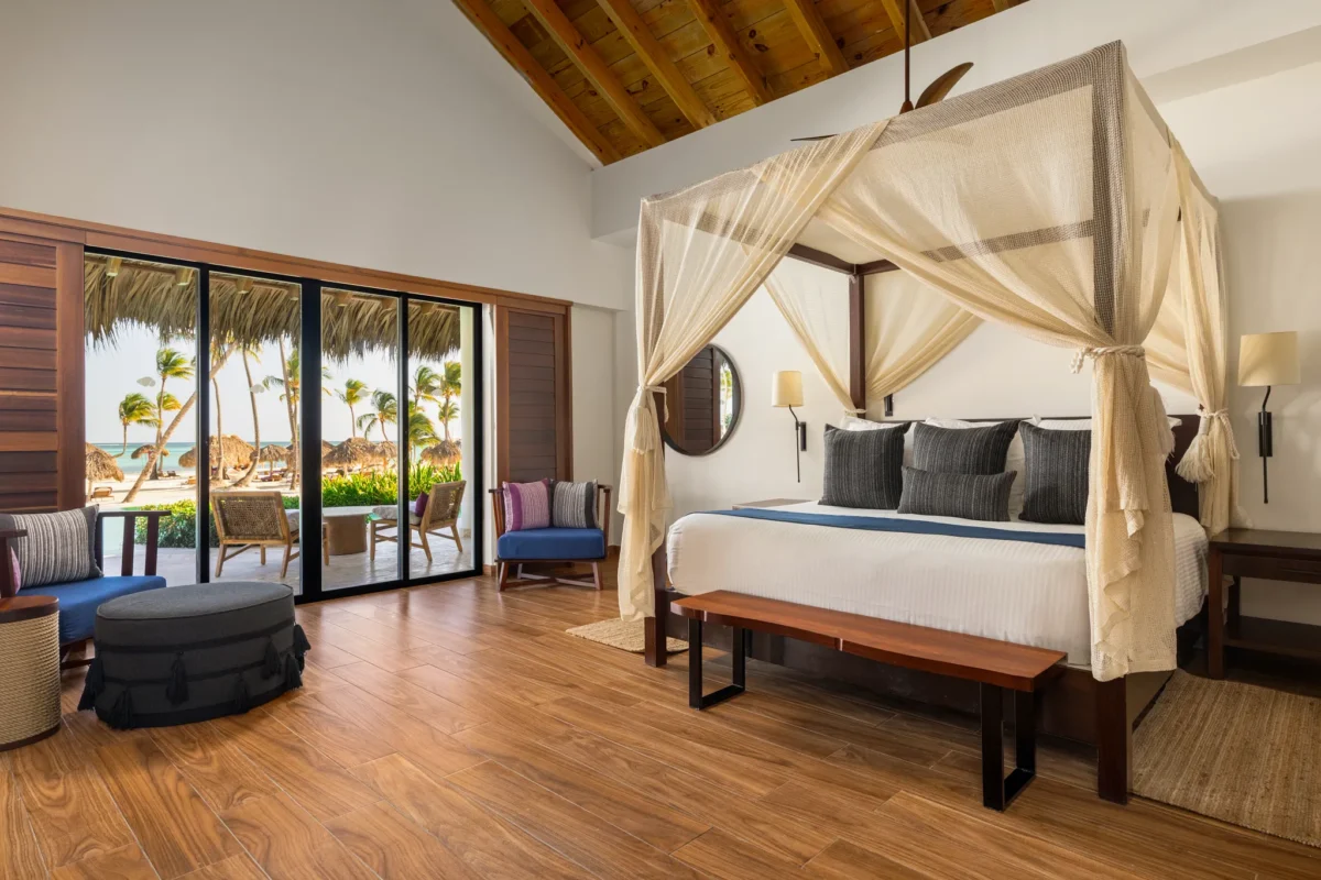 Preferred Club Bungalow Presidential Suite bedroom with king canopy bed and oceanfront terrace at Secrets Cap Cana.