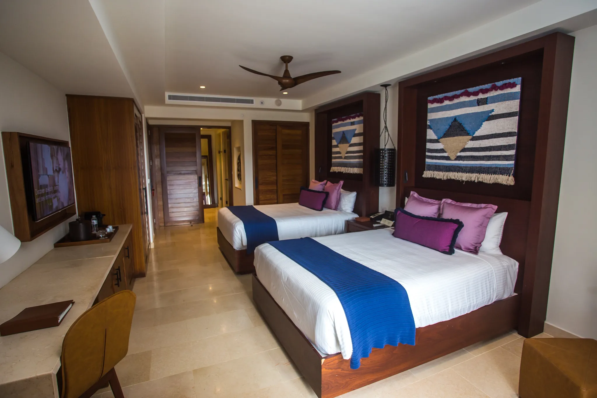 Preferred Club Junior Suite Ocean View with two double beds, spacious layout, and upscale furnishings at Secrets Cap Cana Resort & Spa.