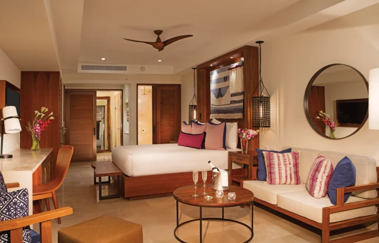 Preferred Club Junior Suite Swim Out Pool View with king-size bed, sitting area, and elegant Caribbean-inspired décor at Secrets Cap Cana Resort & Spa.
