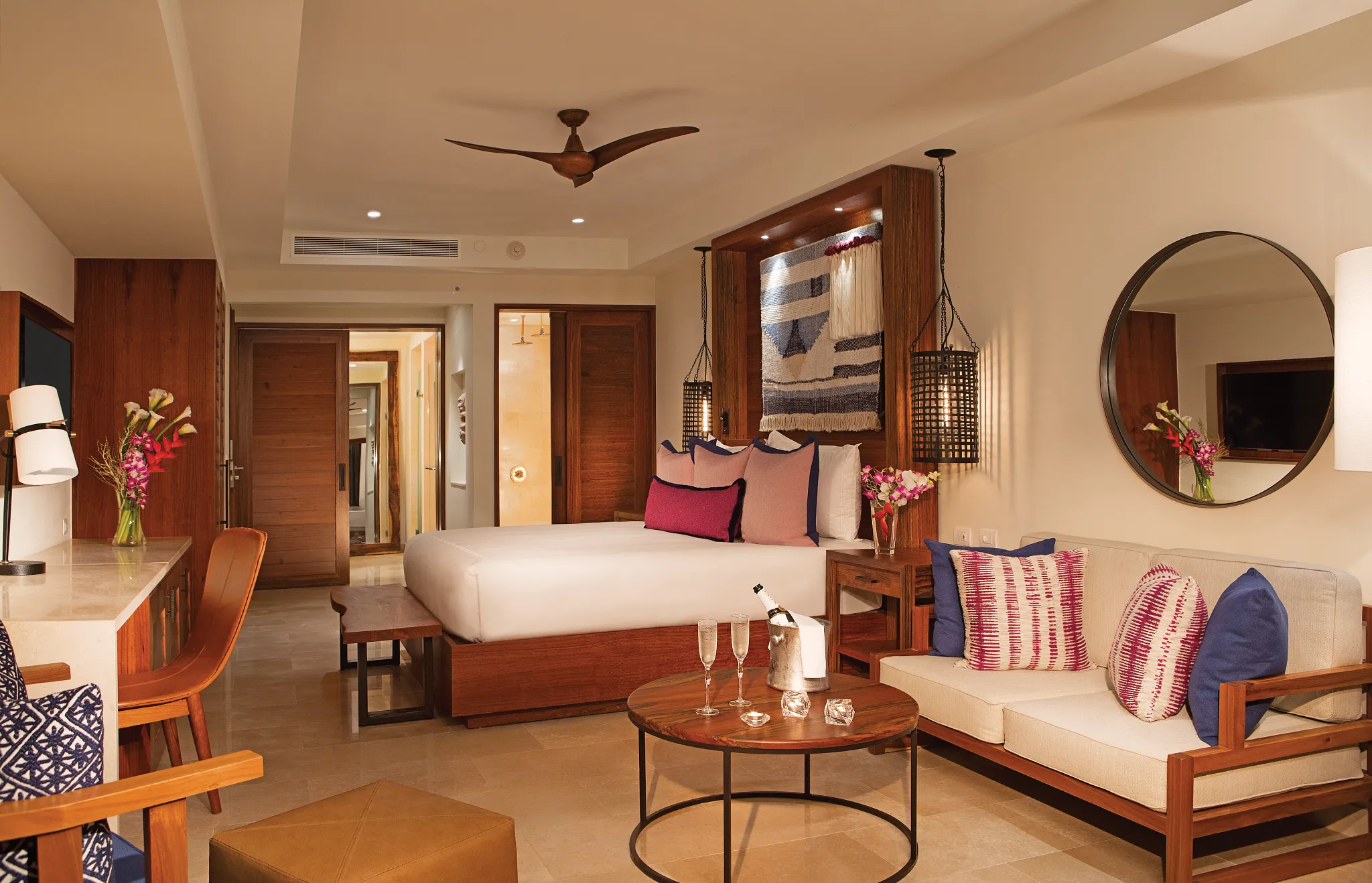 Preferred Club Junior Suite Tropical View with king bed, sitting area, and Caribbean-inspired décor at Secrets Cap Cana Resort & Spa.