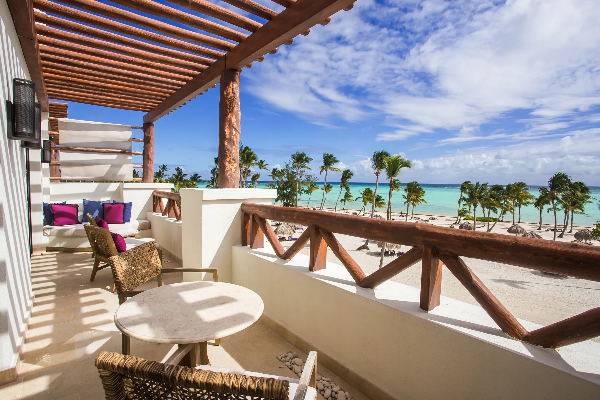 Preferred Club Master Suite Ocean Front balcony with seating area, soaking tub, and panoramic Caribbean Sea views.