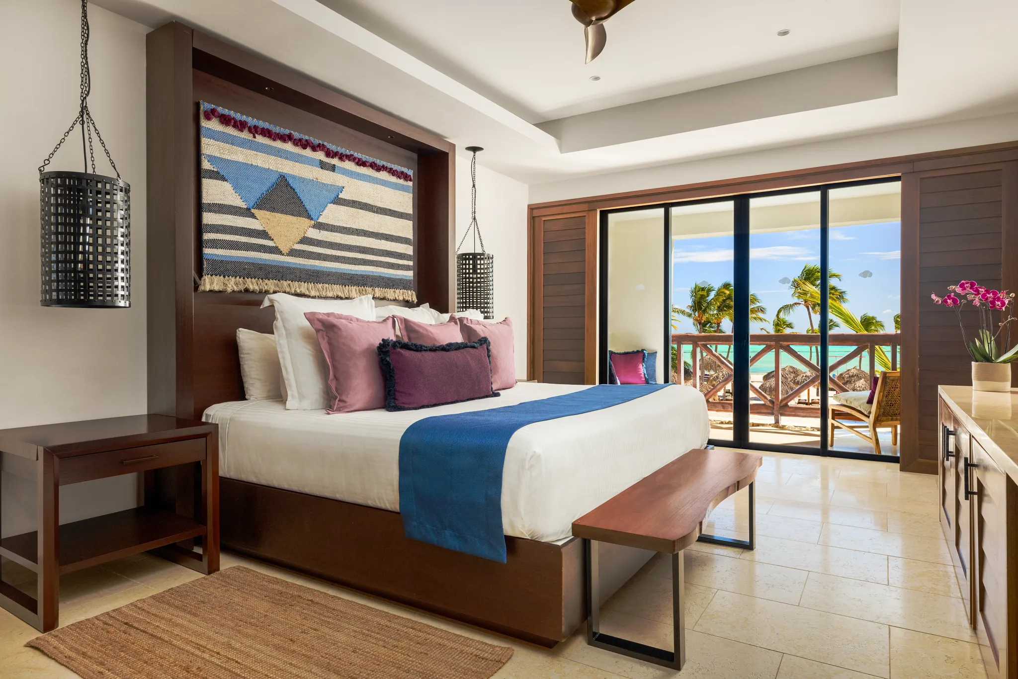 Preferred Club Master Suite Ocean Front bedroom with king-size bed, oceanfront balcony, and Caribbean-inspired luxury décor.