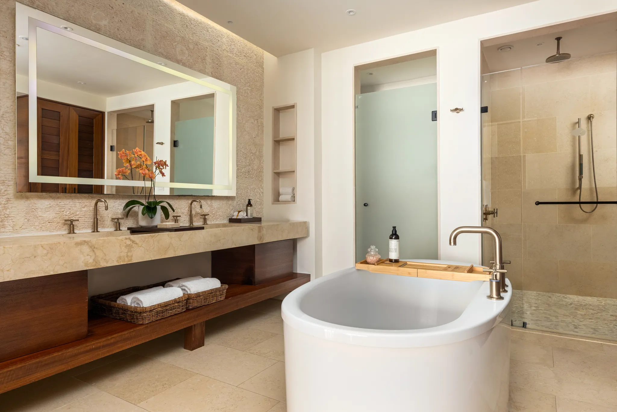 Preferred Club Presidential Suite bathroom with freestanding soaking tub and dual rain showers at Secrets Cap Cana Resort & Spa.
