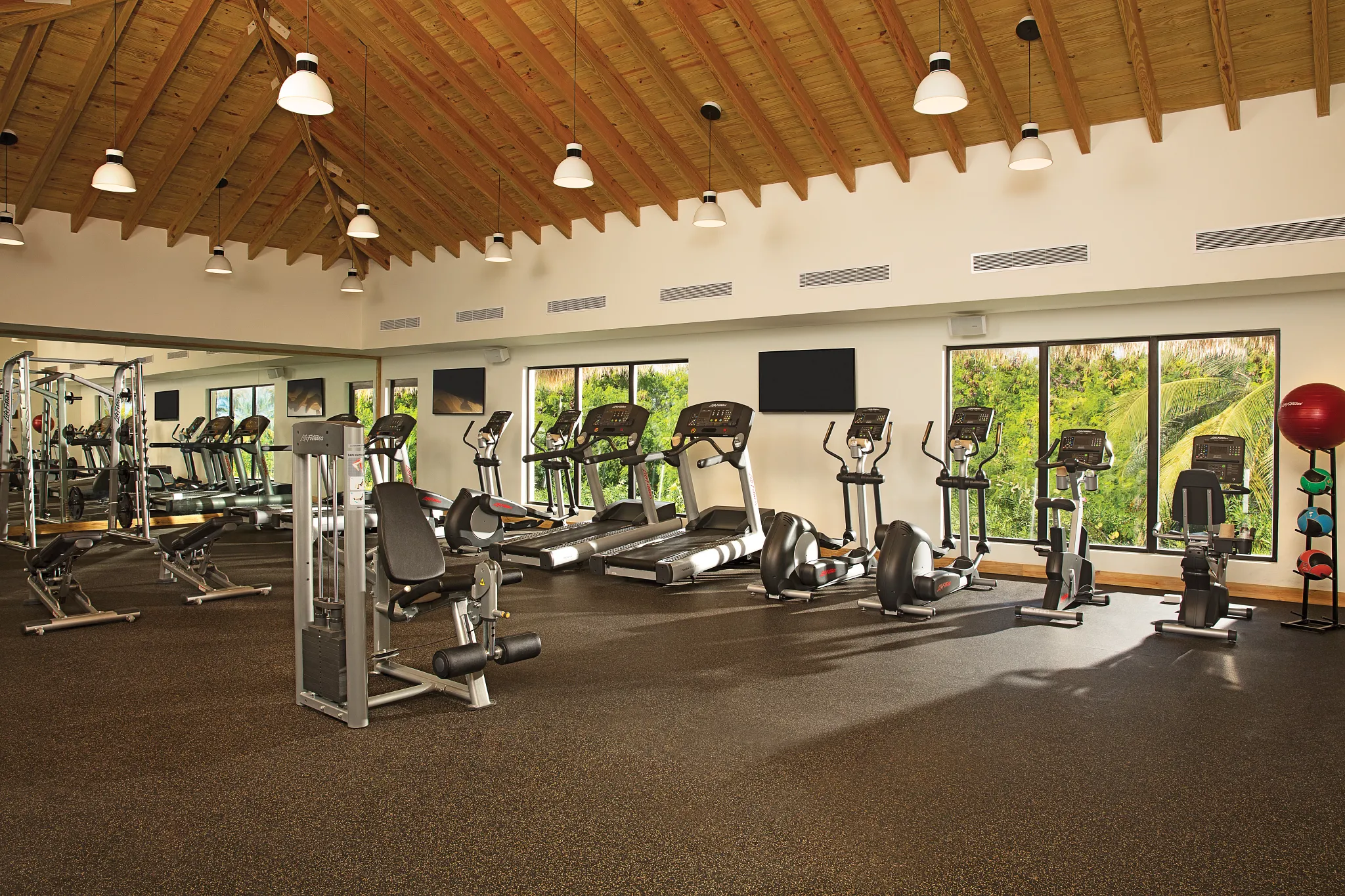 Modern fitness center with cardio and strength-training equipment at Secrets Cap Cana Resort & Spa.