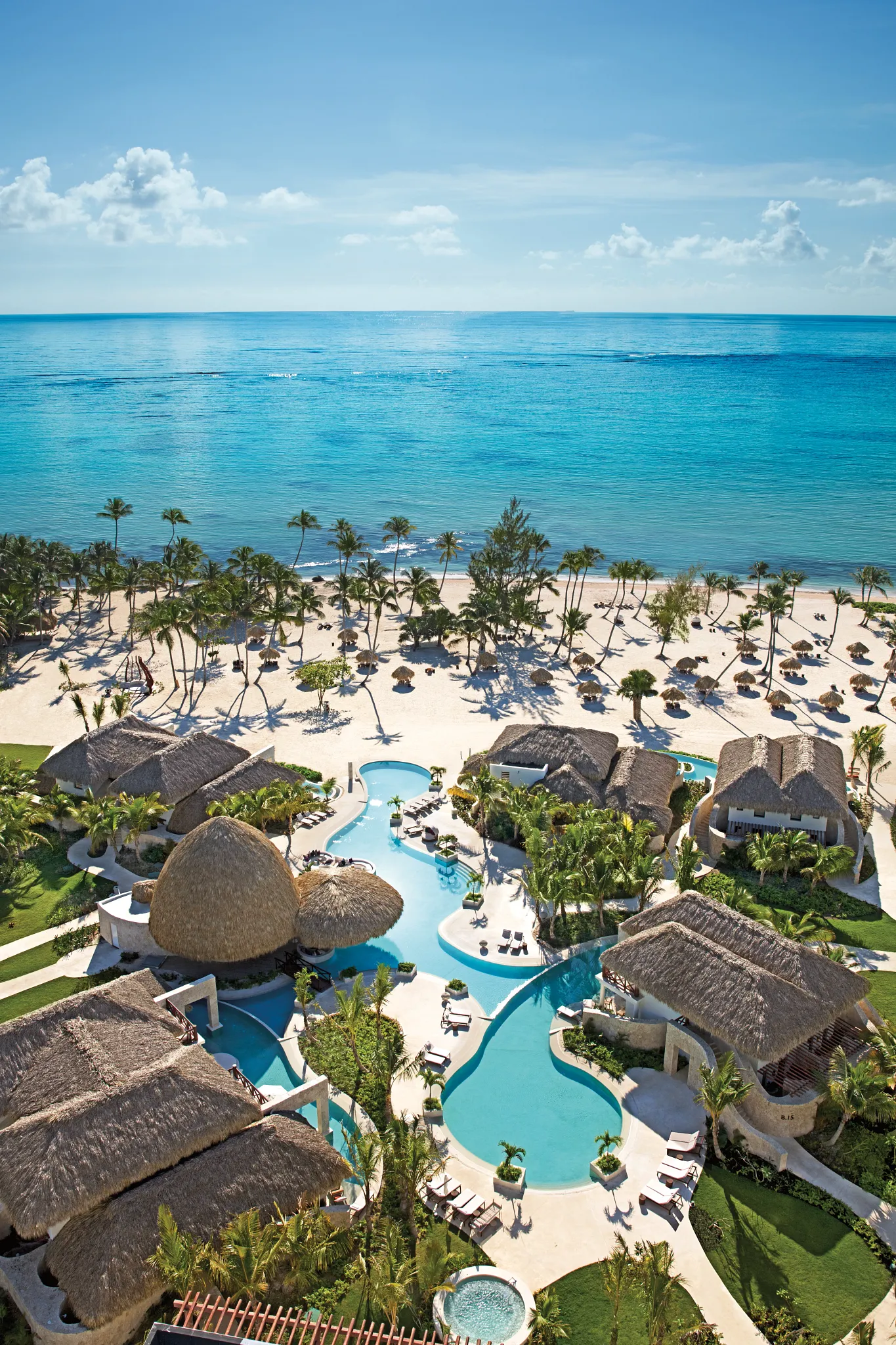 Aerial view of the Preferred Club bungalows and private pool area at Secrets Cap Cana Resort & Spa overlooking the Caribbean Sea.